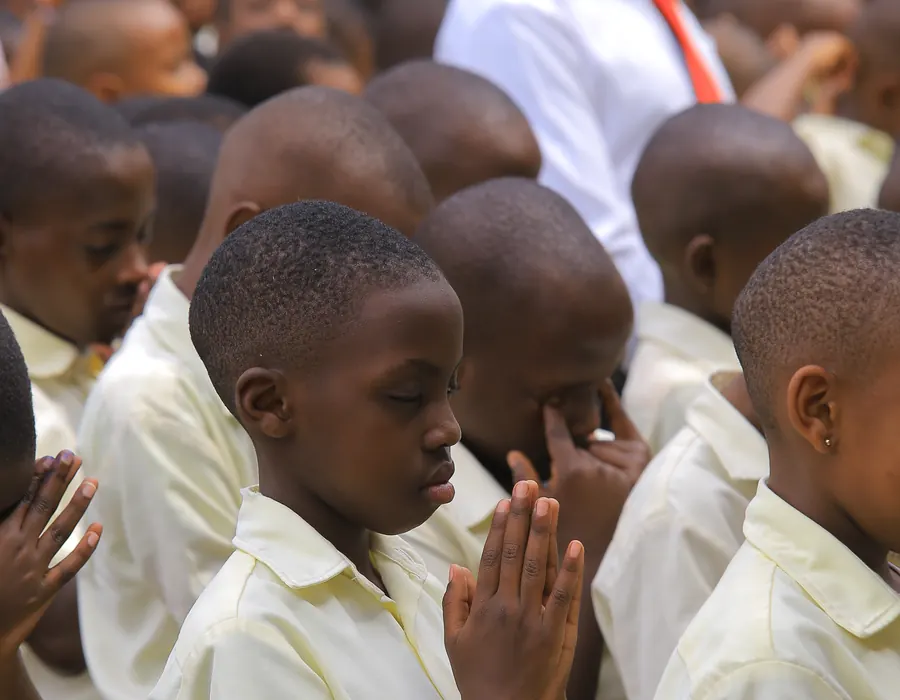 Pupils praying at morning assembly