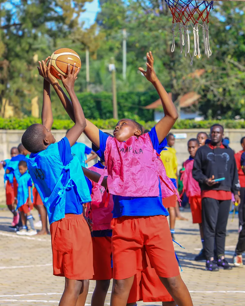 Pupils jumping for the ball in basketball