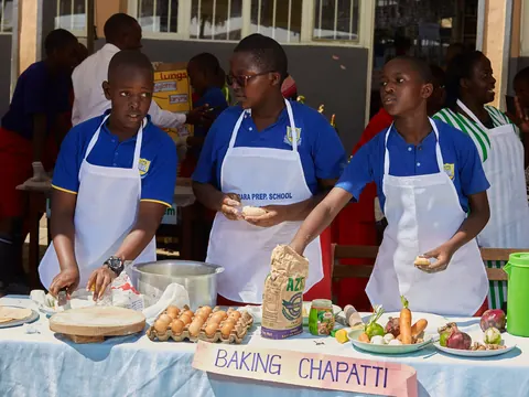 Pupils baking chapati at the projects exhibition