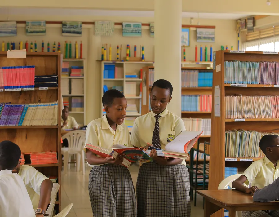 Pupils reading together in the library