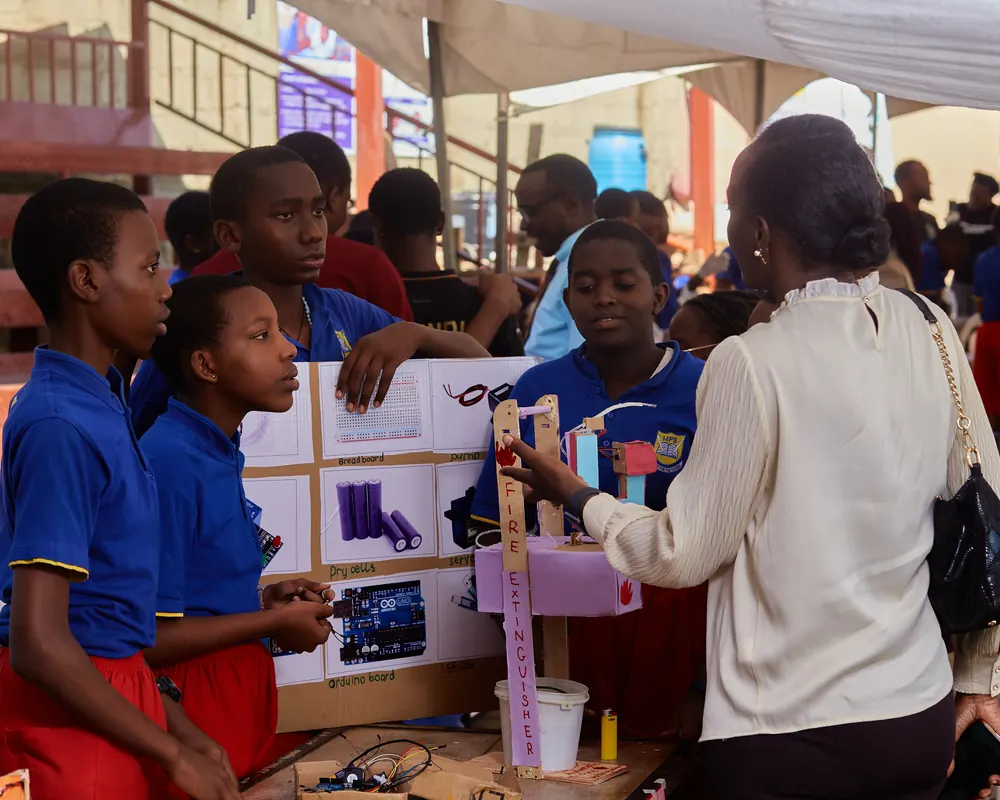 Pupils presenting a science project to a visitor